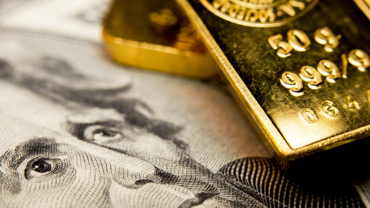 Close-up of a 20-dollar banknote (figuring president Jackson) and a gold bullion