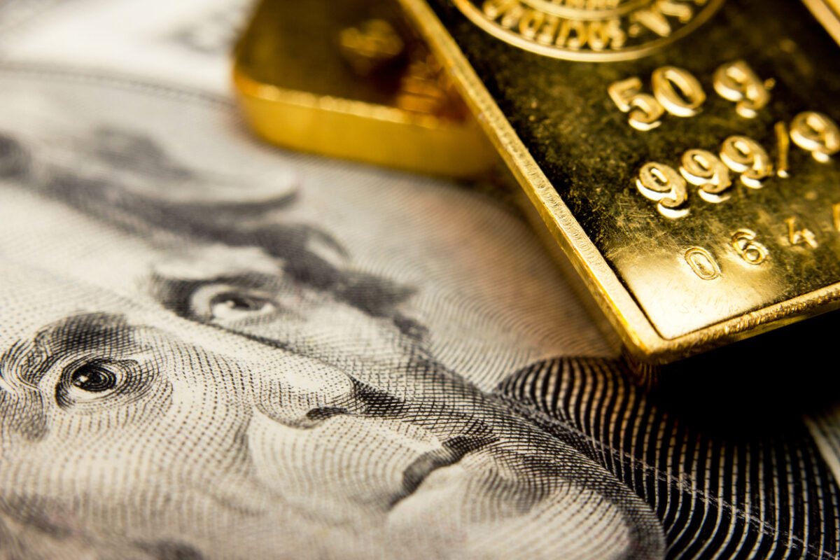 Close-up of a 20-dollar banknote (figuring president Jackson) and a gold bullion