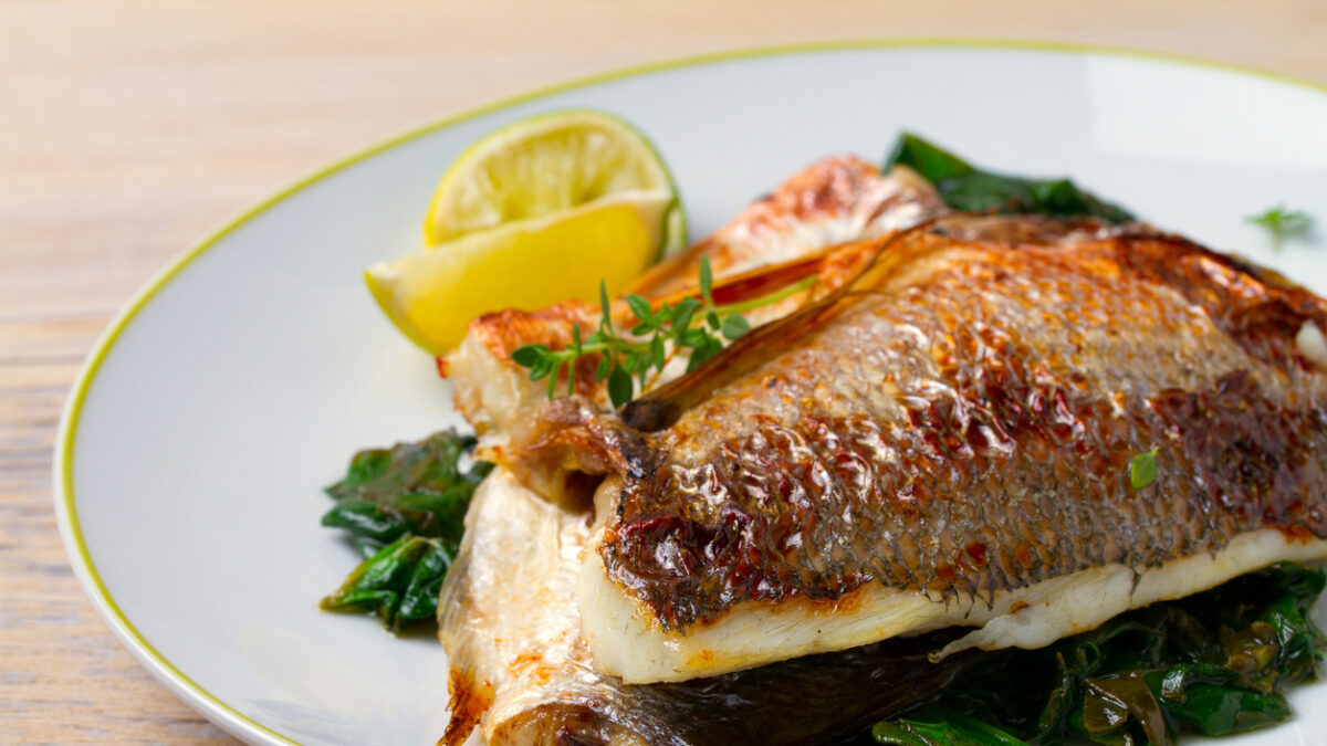 Dorado or dorada fish fillet with spinach, thyme and lime, horizontal