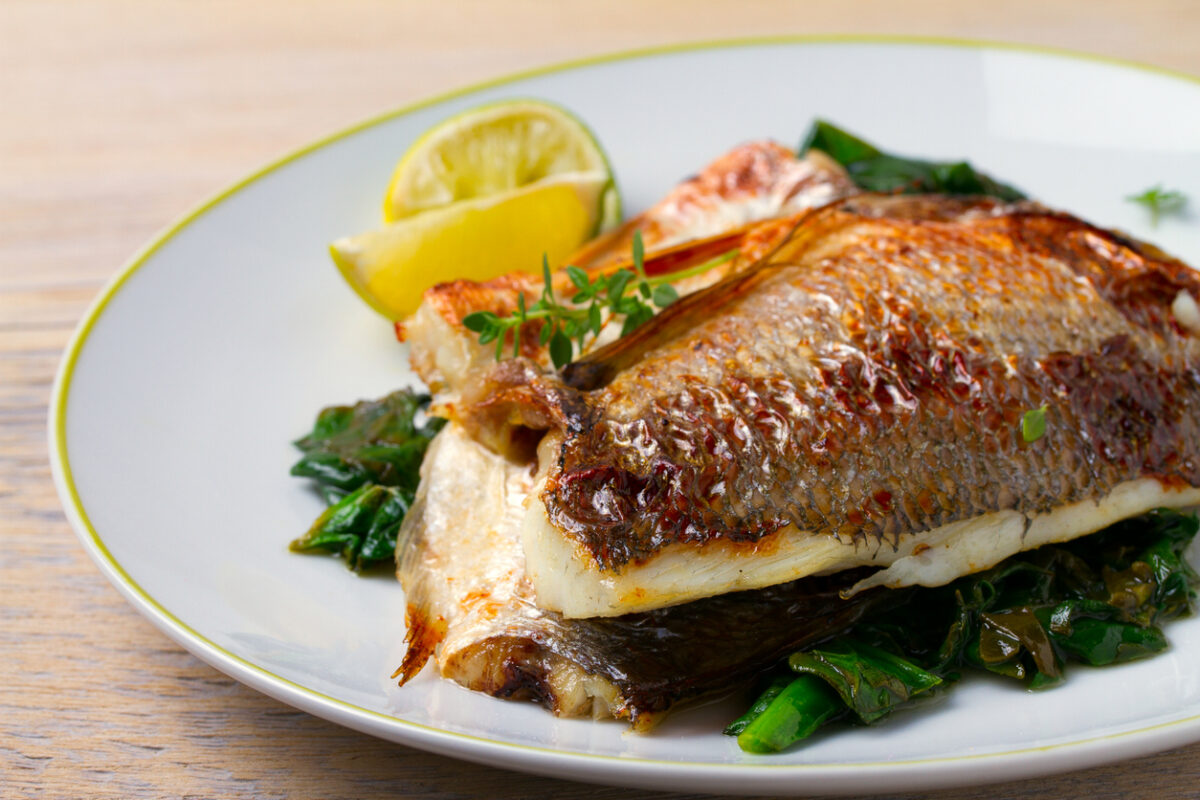 Dorado or dorada fish fillet with spinach, thyme and lime, horizontal