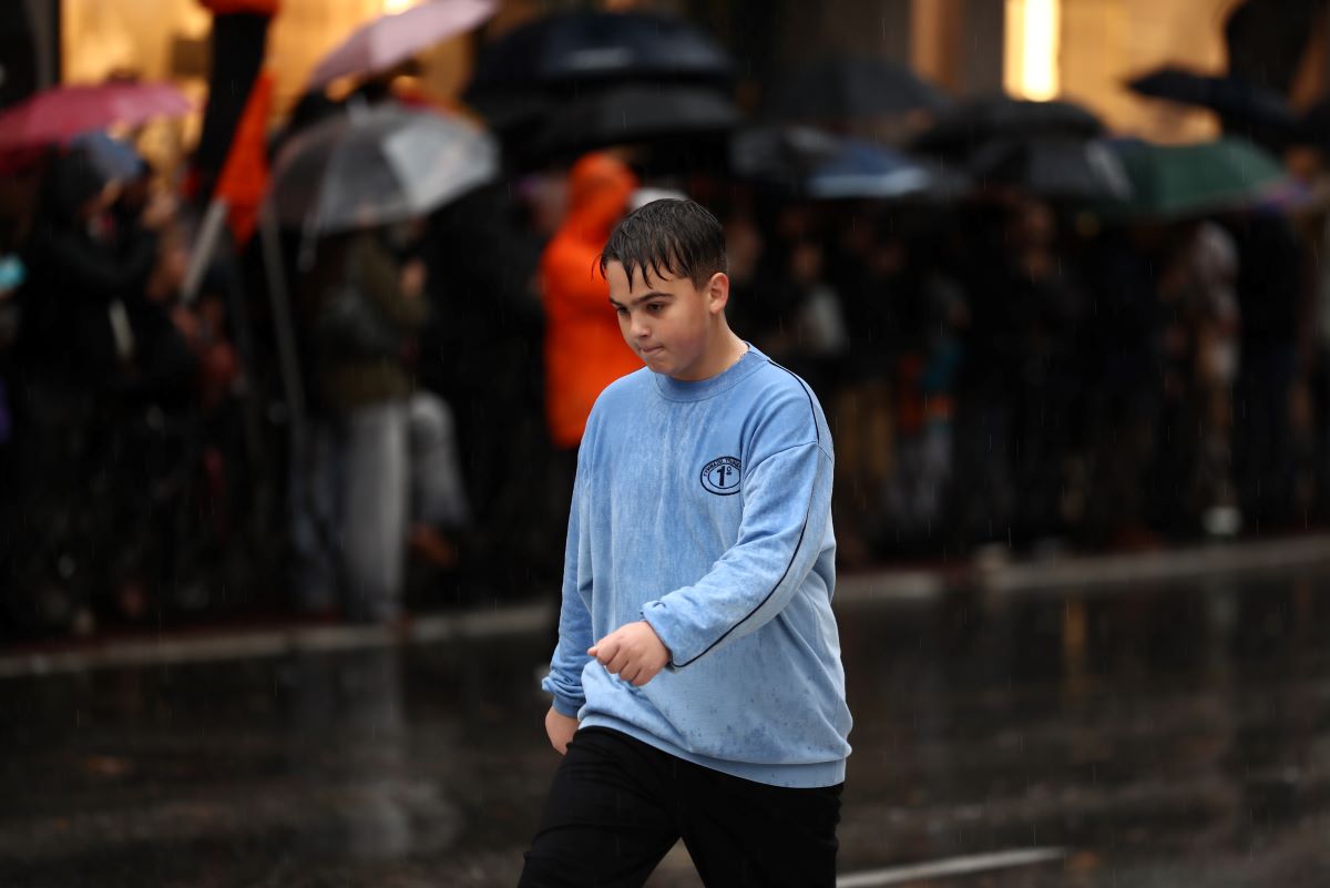 A student marches in the rain in Thessaloniki