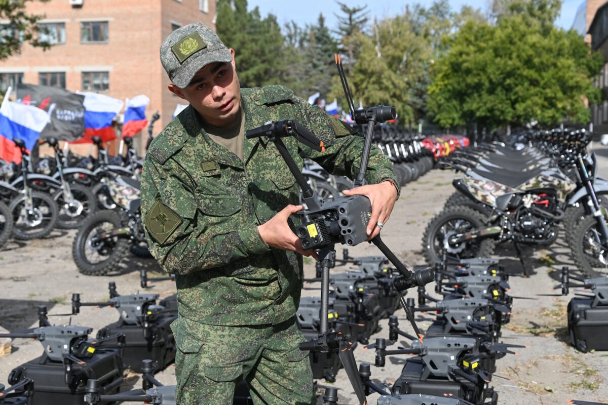 A Russian service member holds a drone during a ceremony organized by the People's Front political movement to hand over new motocross bikes, quad bikes and unmanned aerial vehicles to Russia's army for use in the ongoing military conflict against Ukraine, in Rostov-on-Don, Russia, October 3, 2025. REUTERS