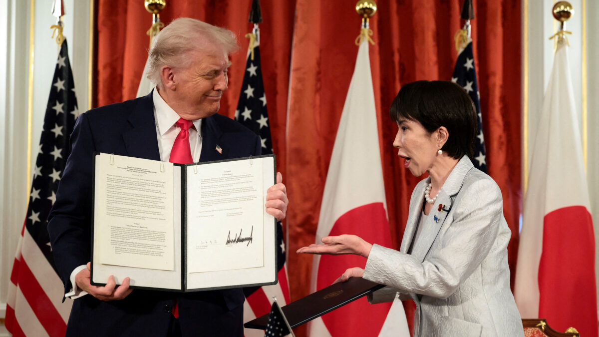 Japanese Prime Minister Sanae Takaichi reacts as U.S. President Donald Trump holds up a signed document regarding securing the supply of critical minerals and rare earths, at a bilateral meeting at Akasaka Palace in Tokyo