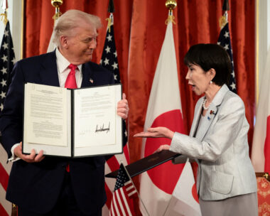 Japanese Prime Minister Sanae Takaichi reacts as U.S. President Donald Trump holds up a signed document regarding securing the supply of critical minerals and rare earths, at a bilateral meeting at Akasaka Palace in Tokyo