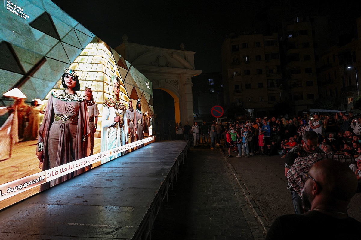 People watch the official opening ceremony of the Grand Egyptian Museum (GEM) on a big screen in the downtown area near Tahrir Square, in front of Abdeen Palace Museum, in Cairo, Egypt, November 1, 2025. REUTERS/Amr Abdallah Dalsh