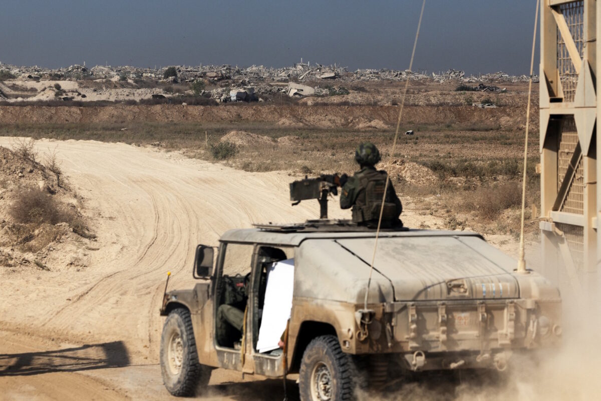 Israeli soldiers enter the Gaza Strip in a military vehicle from at the Israel-Gaza border, November 5, 2025. REUTERS