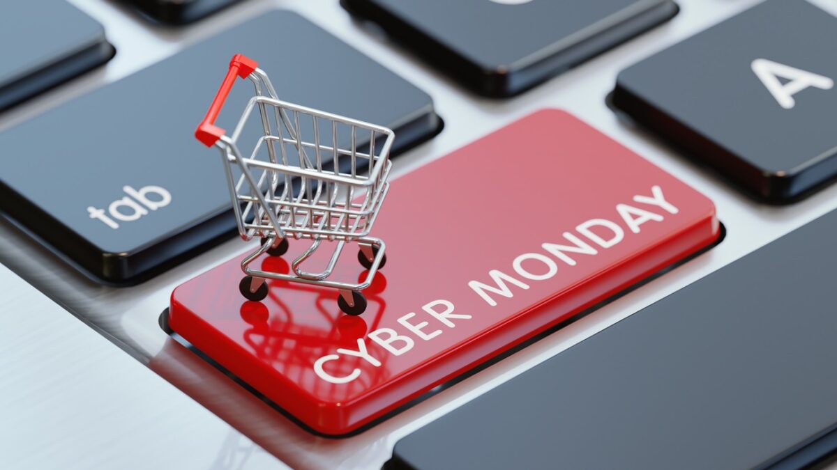 Modern computer keyboard with a shopping cart and a red Cyber Monday button. Horizontal composition with selective focus and copy space. Great use for shopping and Cyber Monday related concepts.