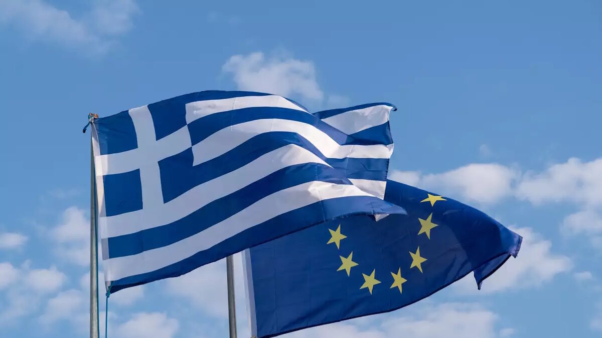 The national flag of Greece and the flag of the European Union.
