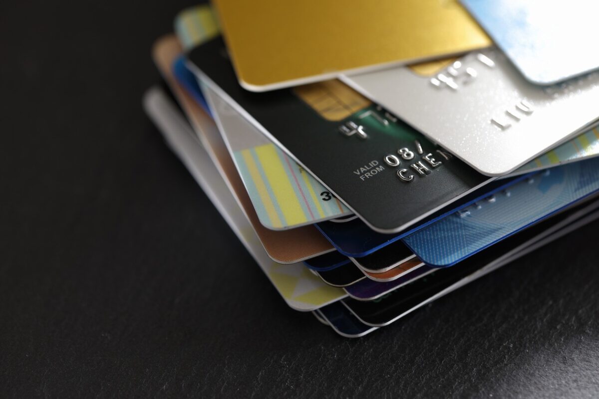 stack of multicolored credit cards on black background