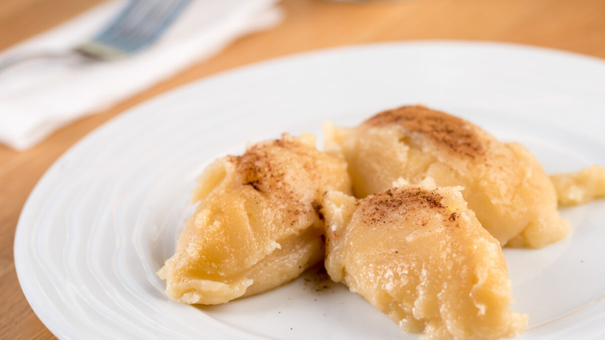 Turkish Flour Halva or Un Helvasi on white plate with cinnamon on top.