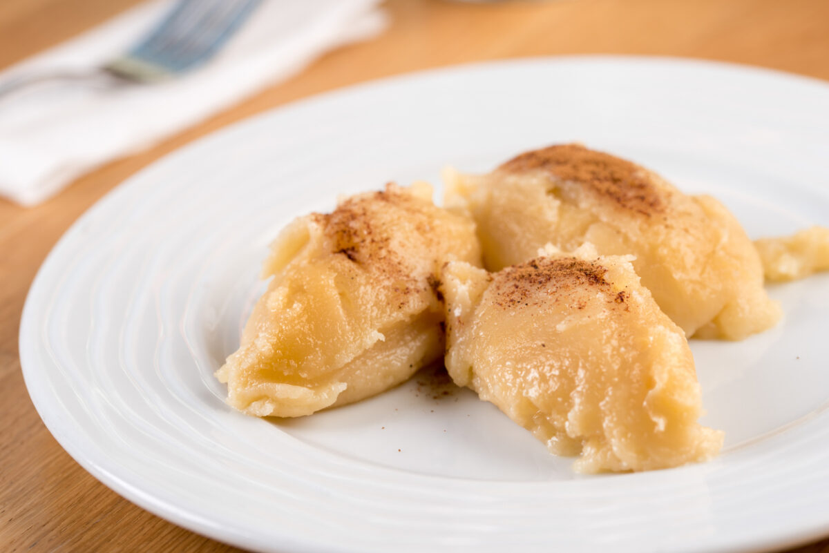 Turkish Flour Halva or Un Helvasi on white plate with cinnamon on top.