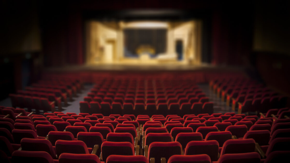 Empty red armchairs of a theater ready for a show