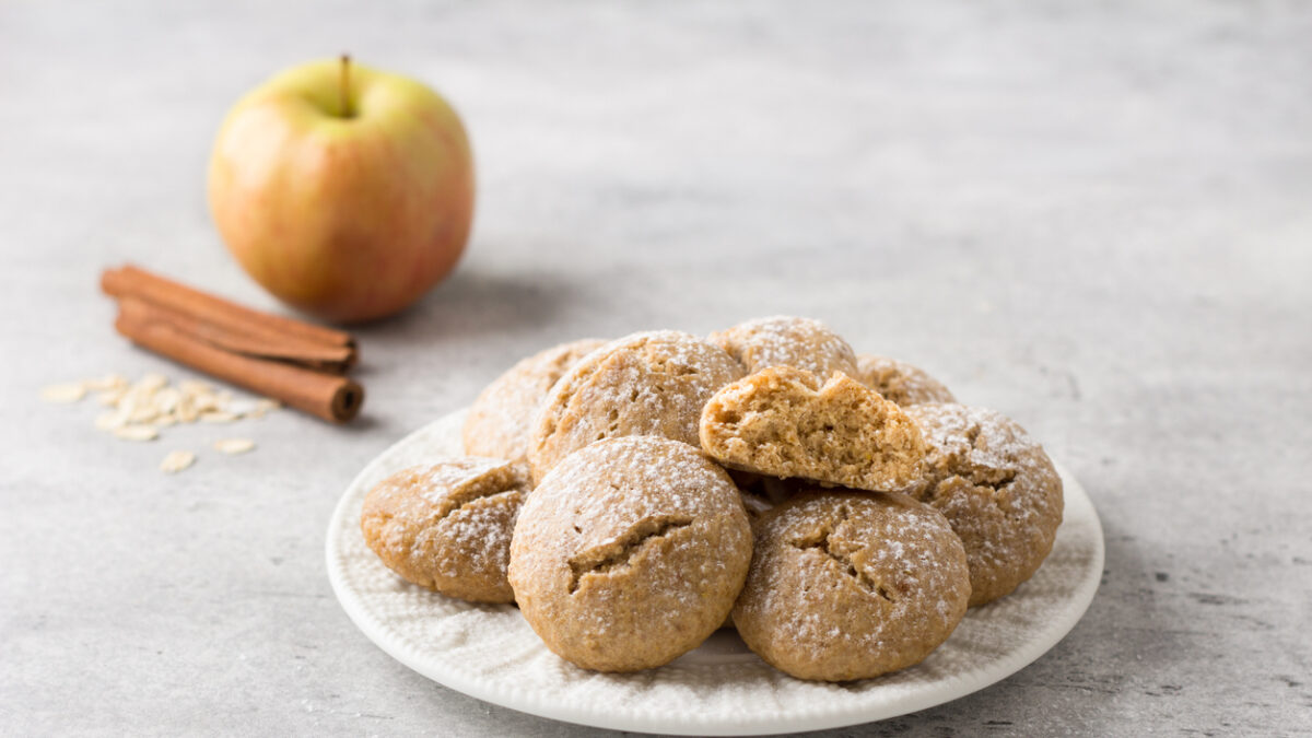 Steamed oatmeal cookies with apple and cinnamon sprinkled with powdered sugar on a light gray textured background. healthy homemade food