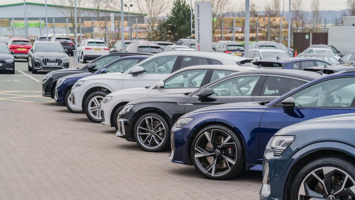 A row of Audis parked at a dealership lot