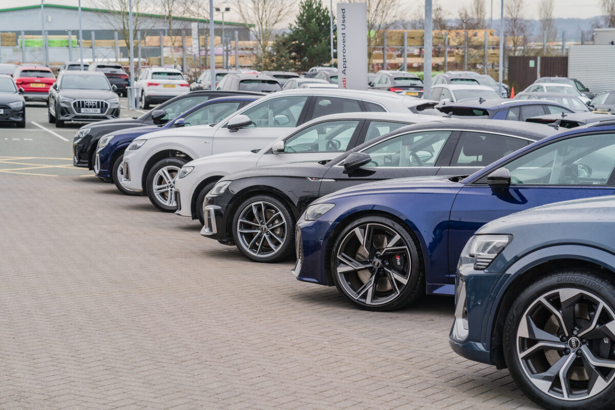 A row of Audis parked at a dealership lot