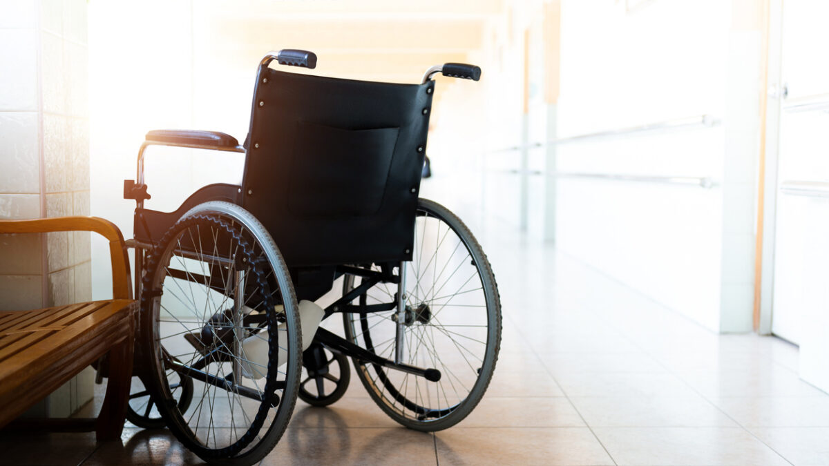 Single wheelchair parked in hospital hallway