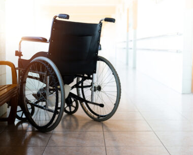 Single wheelchair parked in hospital hallway