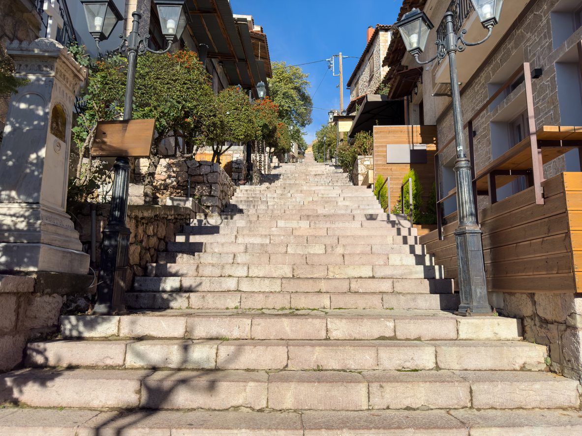 Greece Arachova village, stone stairs and buildings at the center of small town. Tourist resort for winter sports, sunny summer day