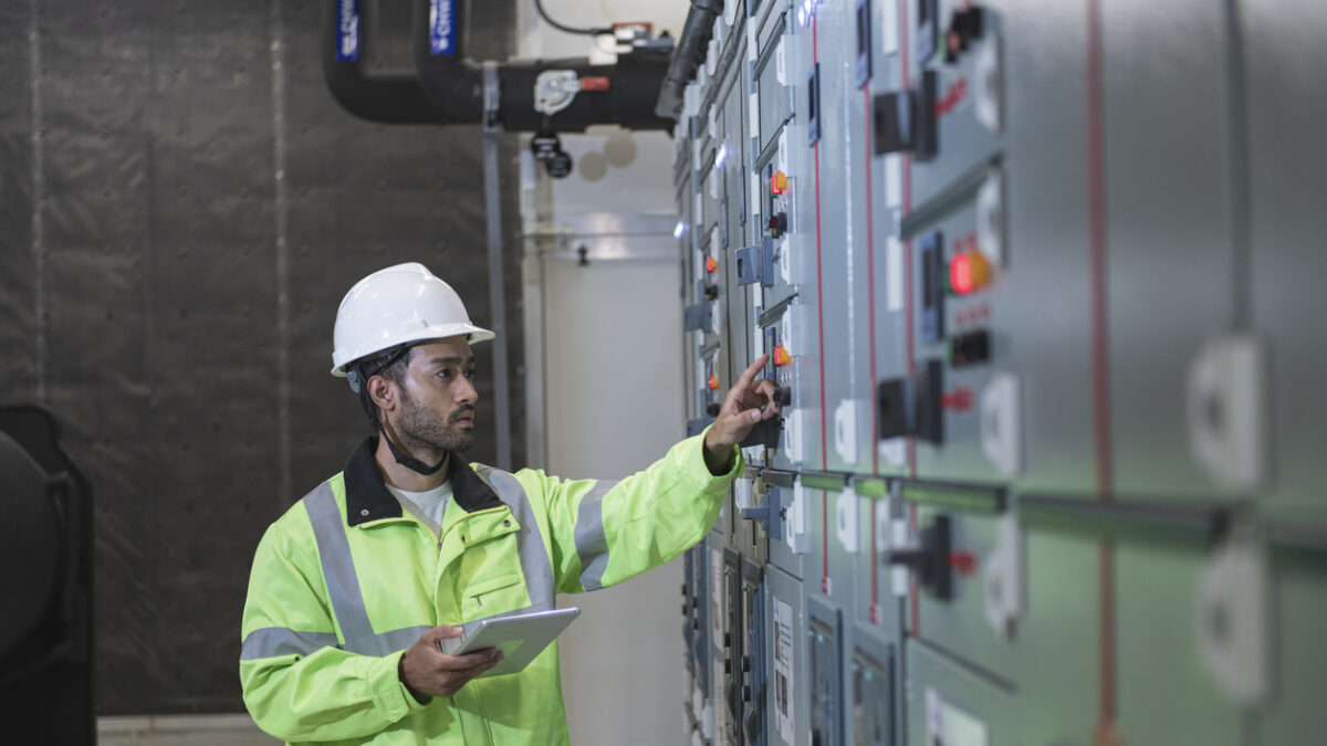 male worker work on panel board in main distribution station room