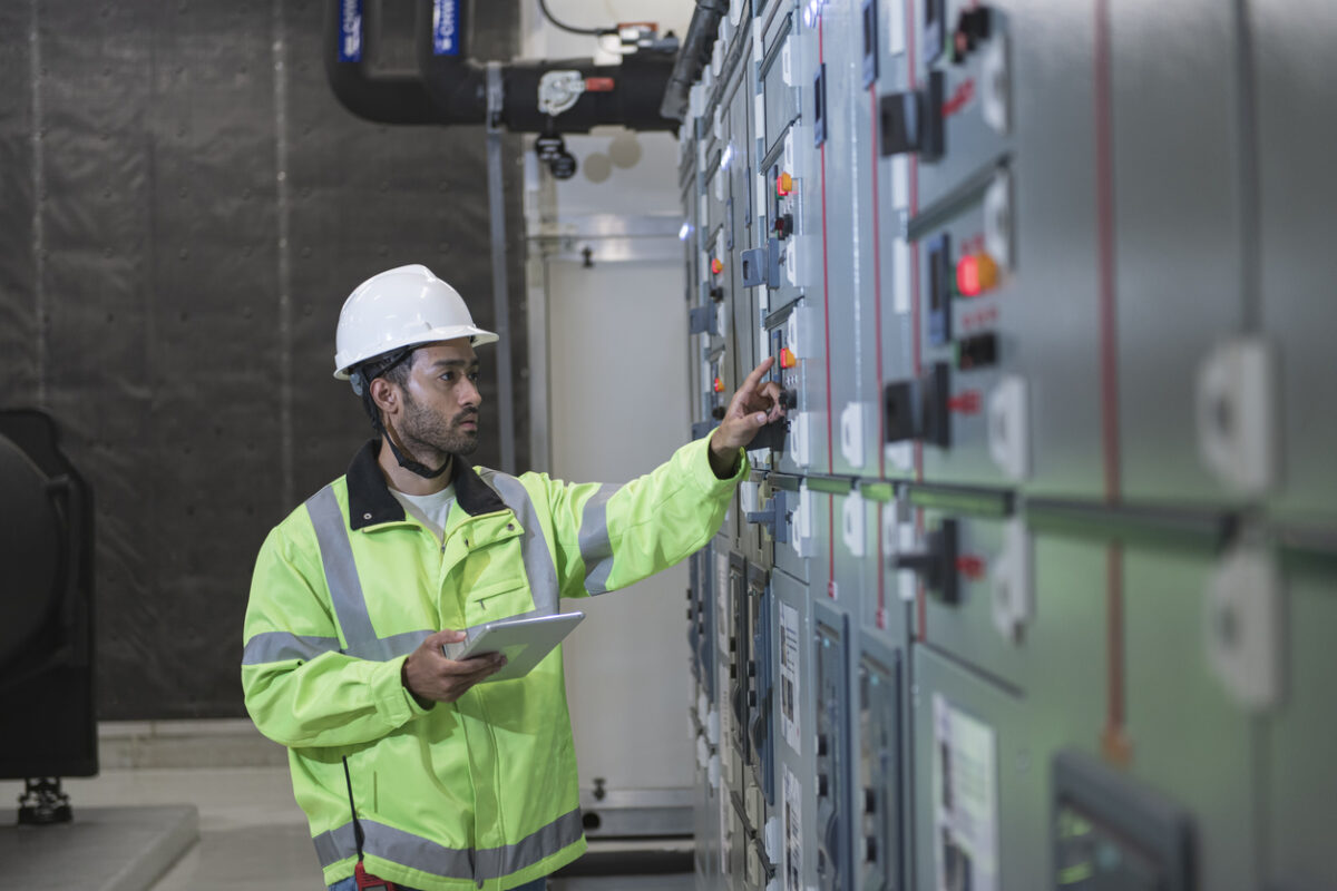 male worker work on panel board in main distribution station room