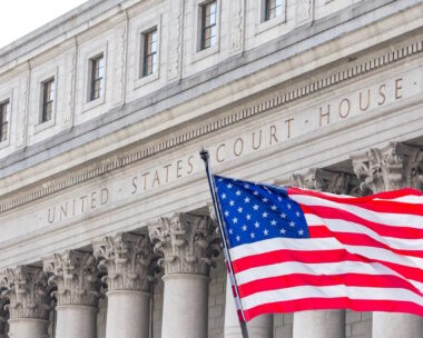 USA national flag waving in the wind in front of United States Court House in New York, USA