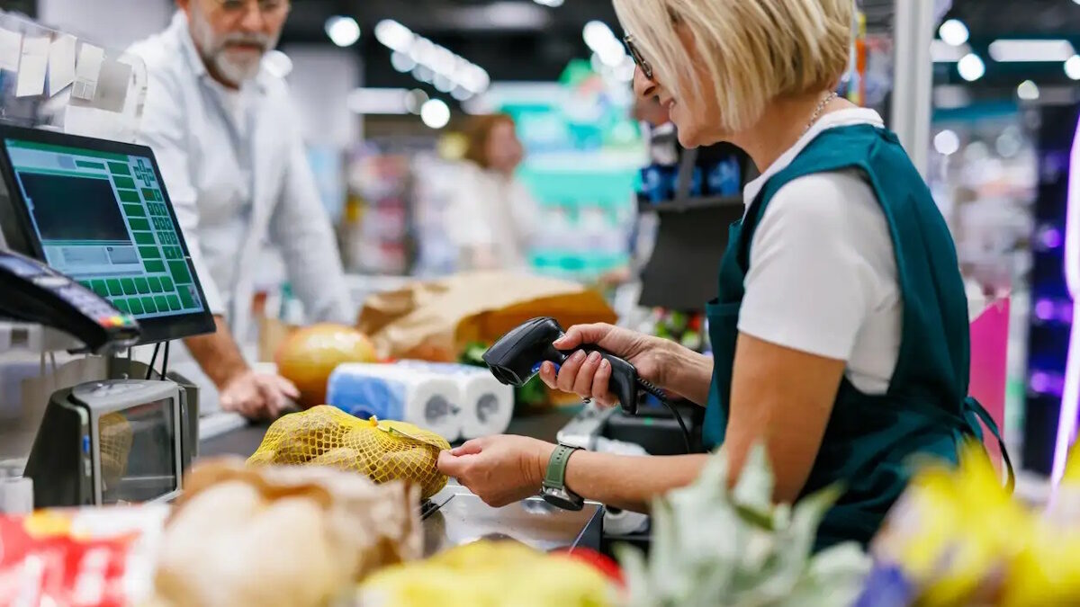 Supermarket cashier scanning groceries