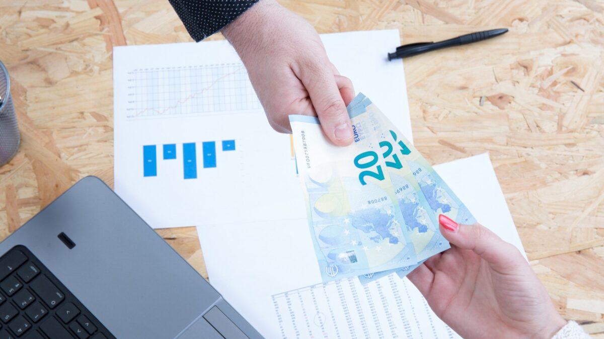 Money on computer keyboard isolated on white