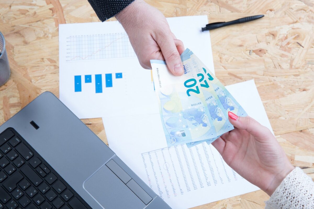 Money on computer keyboard isolated on white