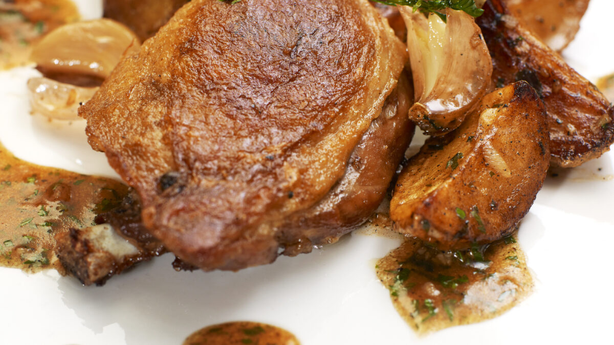Turkey Steak with Herbs,Vegetables, Garlic and Red Sauce. Isolated on white plate.
