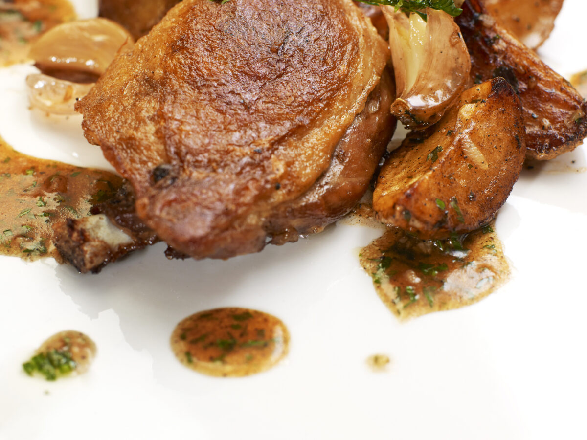 Turkey Steak with Herbs,Vegetables, Garlic and Red Sauce. Isolated on white plate.