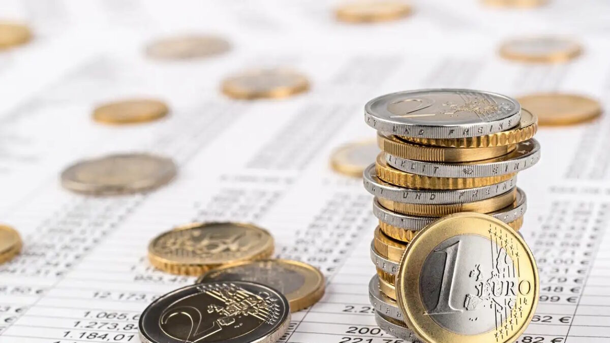 finance business accounting stock background with stack of euro coins on data sheet