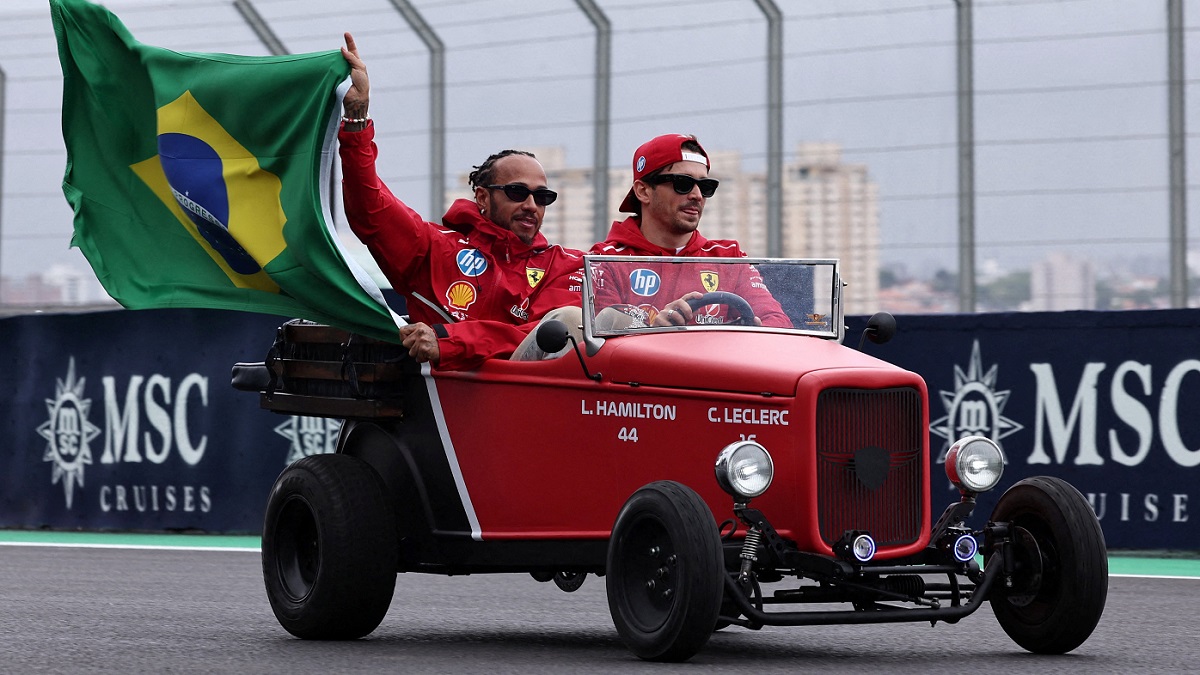 Formula One F1 - Sao Paulo Grand Prix Ferrari's Lewis Hamilton holds a Brazil flag with Ferrari's Charles Leclerc