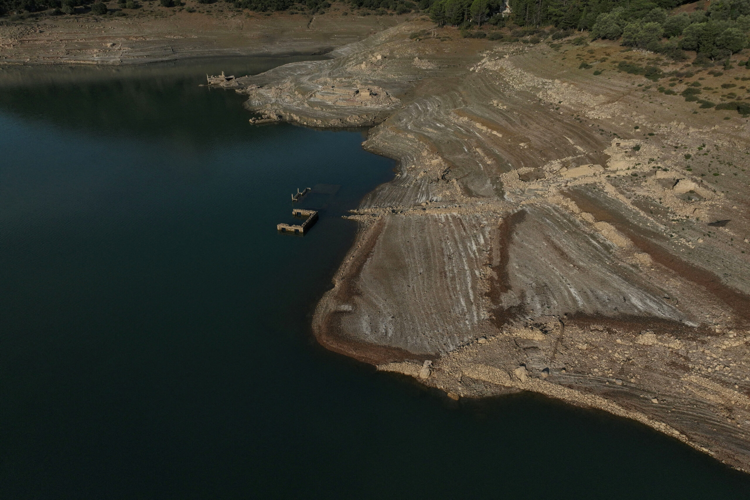 FILE PHOTO: Sunken village emerges in Greece as drought dries up lake A drone view shows the reappearing remains of buildings of the village of Kallio