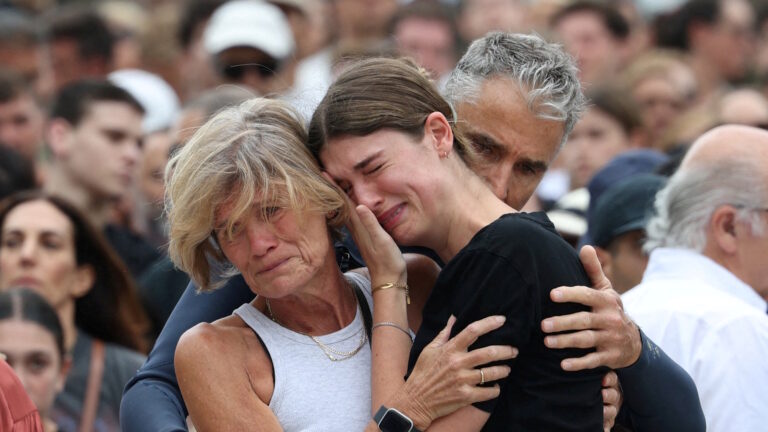 Άνθρωποι θρηνούν τους νεκρούς στην παραλία Μπόντι