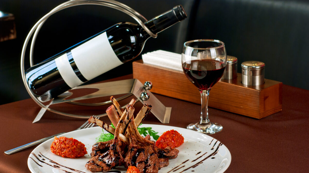 Roasted lamb chops with vegetables on decorated table