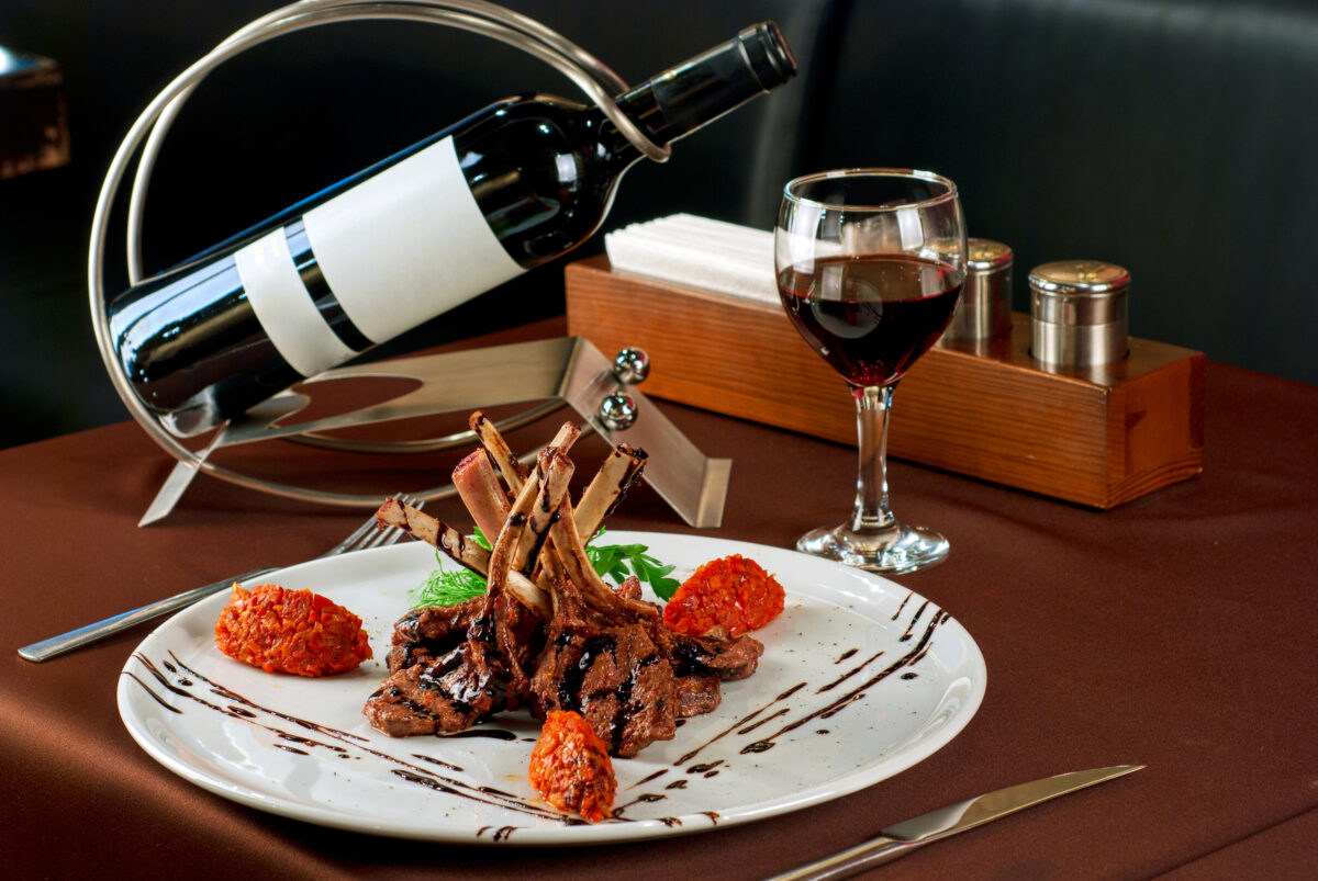Roasted lamb chops with vegetables on decorated table