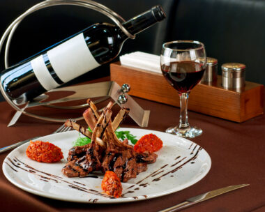 Roasted lamb chops with vegetables on decorated table