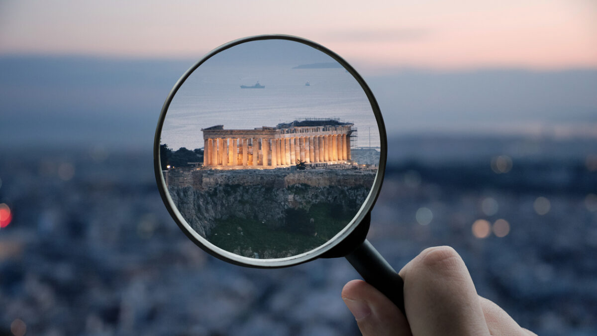 A magnifying glass over the Parthenon building in Athens, Greece