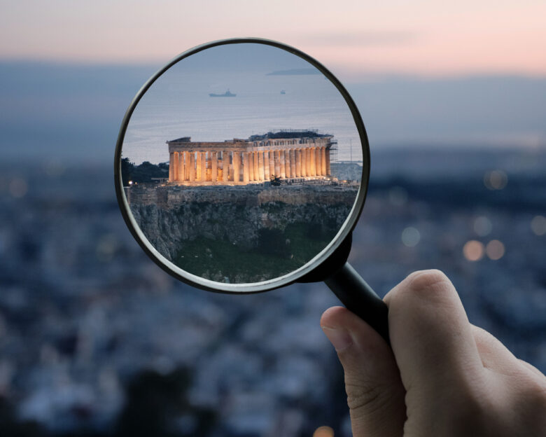 A magnifying glass over the Parthenon building in Athens, Greece