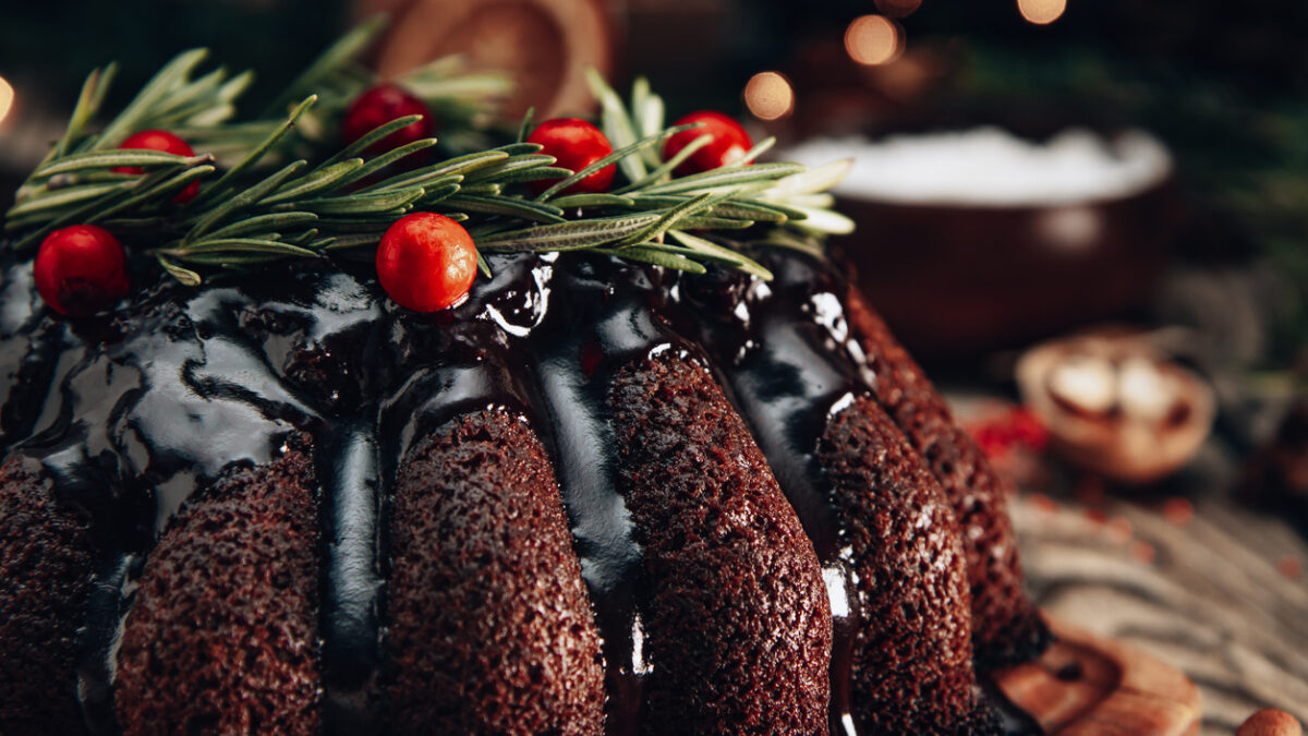 Christmas chocolate cake garnished with berries and rosemary close-up. High quality photo