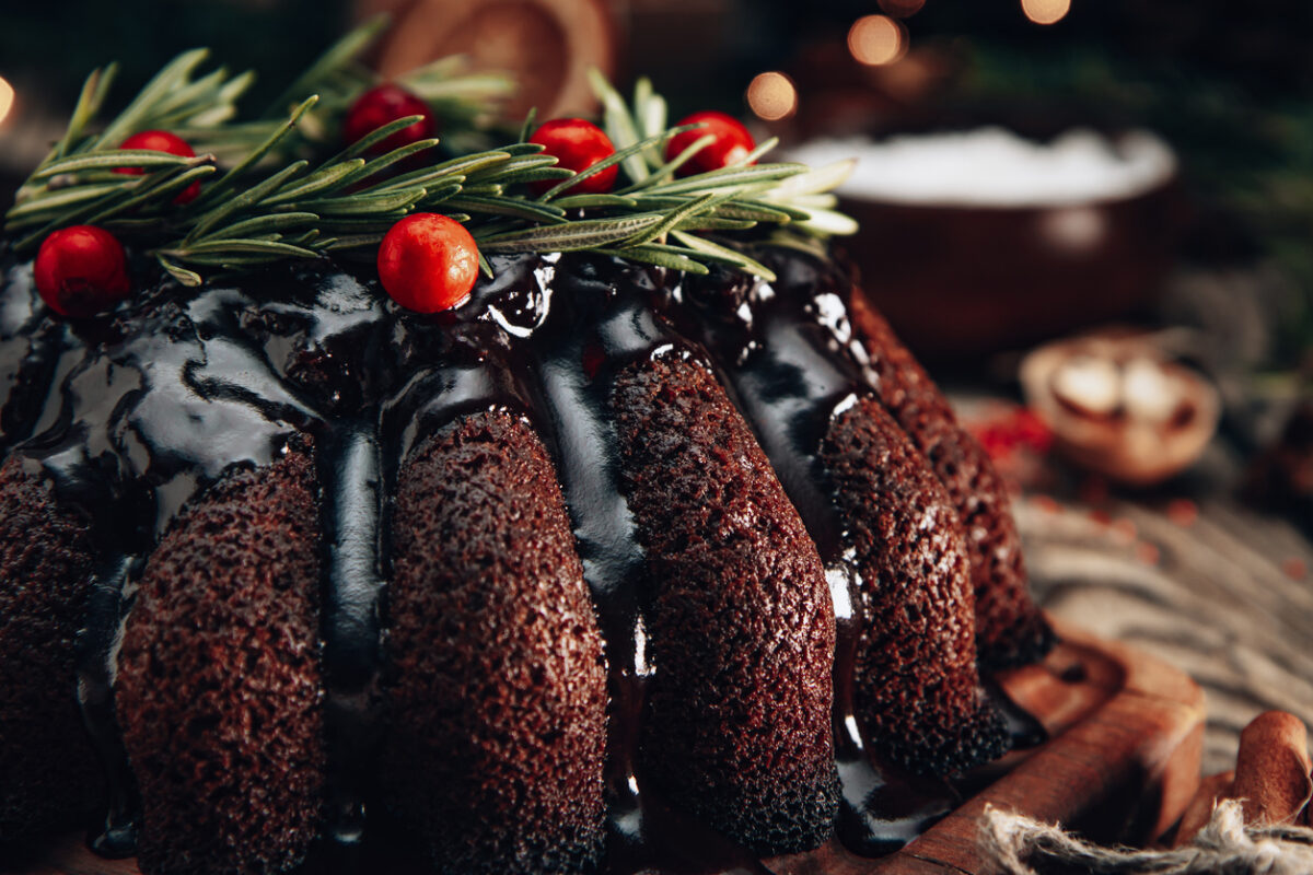 Christmas chocolate cake garnished with berries and rosemary close-up. High quality photo
