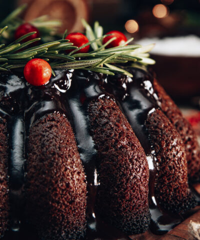 Christmas chocolate cake garnished with berries and rosemary close-up. High quality photo