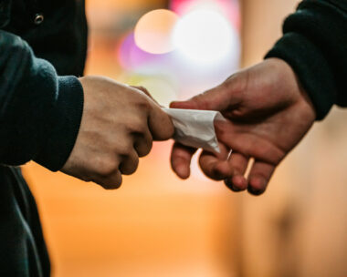 Addict young man have meeting with dealer at night to buy dose of white powder cocaine.