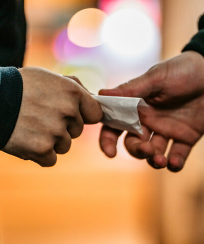 Addict young man have meeting with dealer at night to buy dose of white powder cocaine.