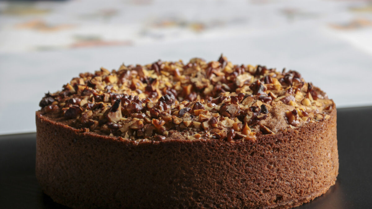 close up of nuts cake on black surface, copy space