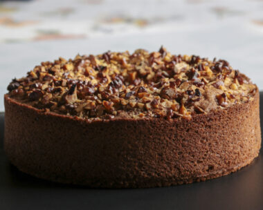 close up of nuts cake on black surface, copy space