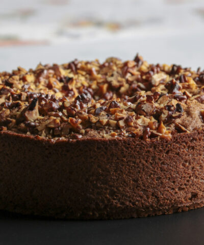 close up of nuts cake on black surface, copy space