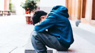 I have a trouble,Boy sitting on floor