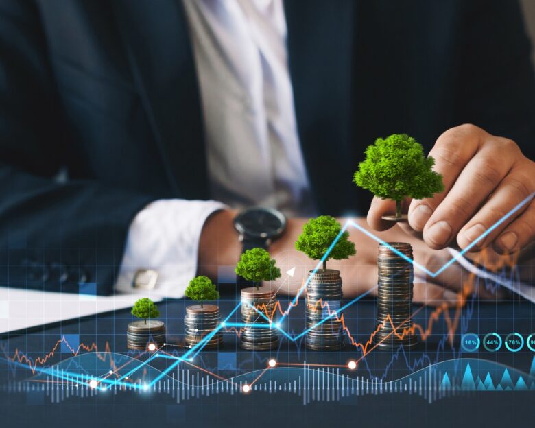 Eco business investment. Green business growth. Businessman holding coin with tree growing on money coin stack. Finance sustainable development.Concept of pass and increase of renewable energy