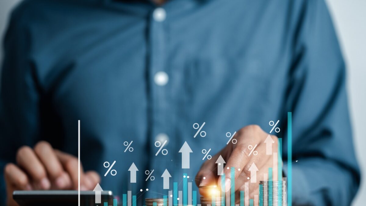 Businessman hand stacking money coins with virtual percentage icons for financial banking increase interest rate, mortgage and property investment dividend value from business growth concept.